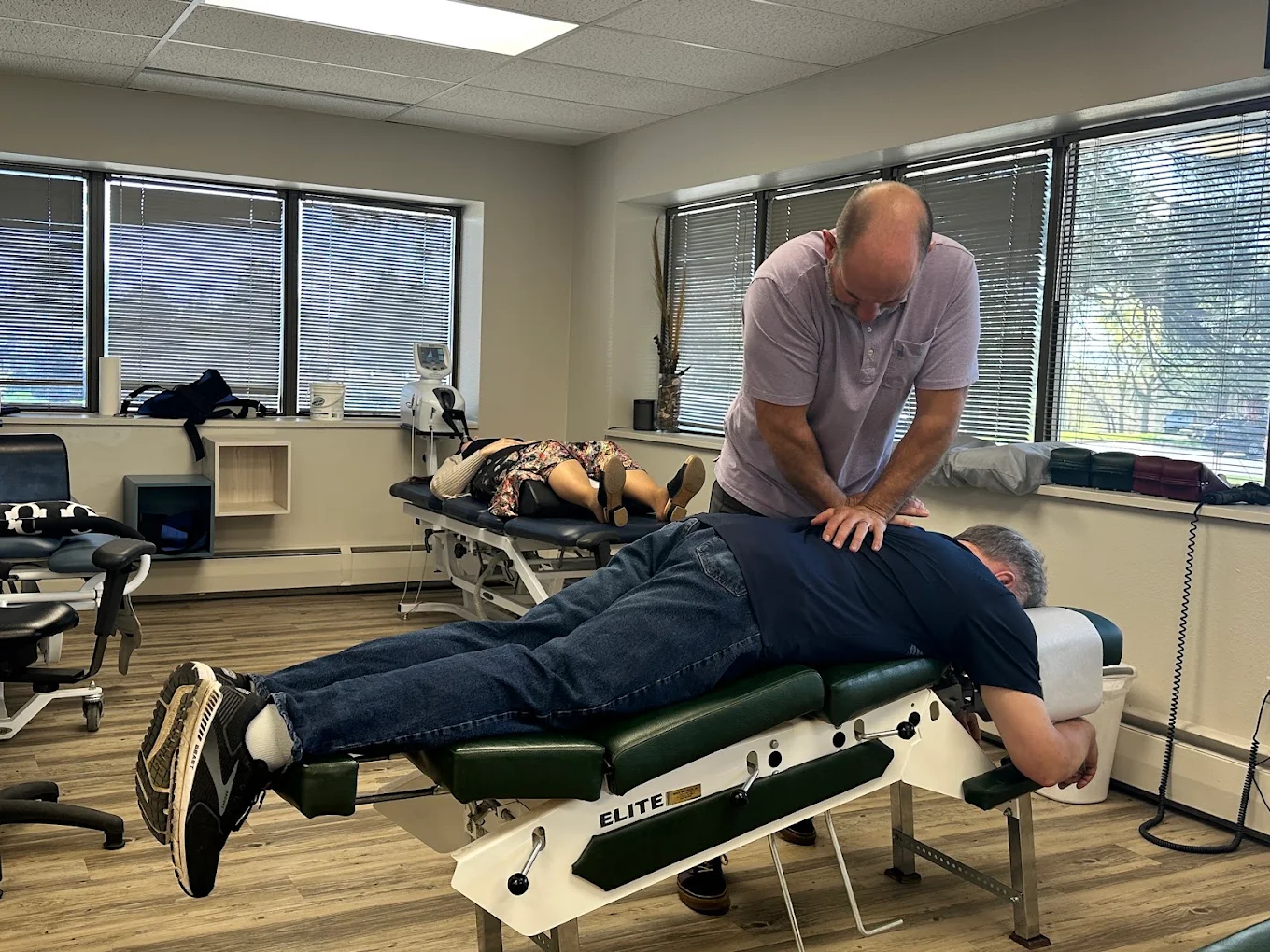 Dr. Tony Nicholas performing a chiropractic adjustment on a patient at Axis Health and Wellness in Centennial CO