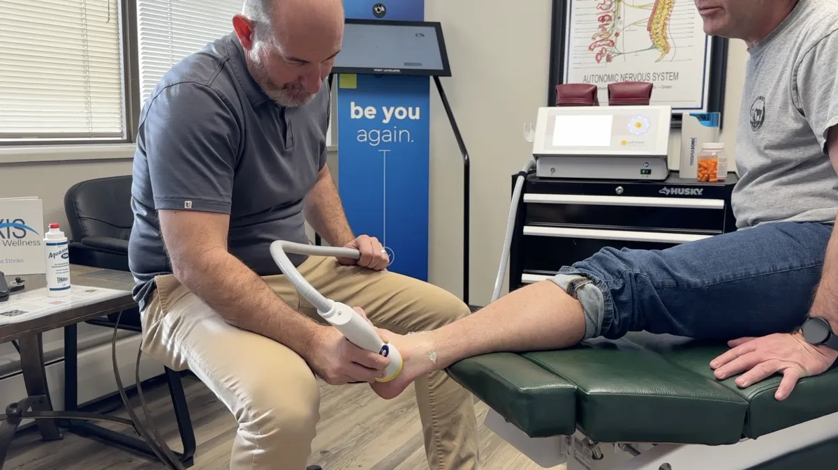Dr. Tony Nicholas performing SoftWave therapy on a patient at Axis Health and Wellness in Centennial CO
