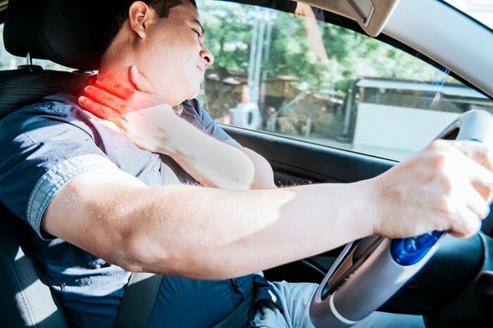 Man suffering from whiplash neck pain after a car accident in Colorado