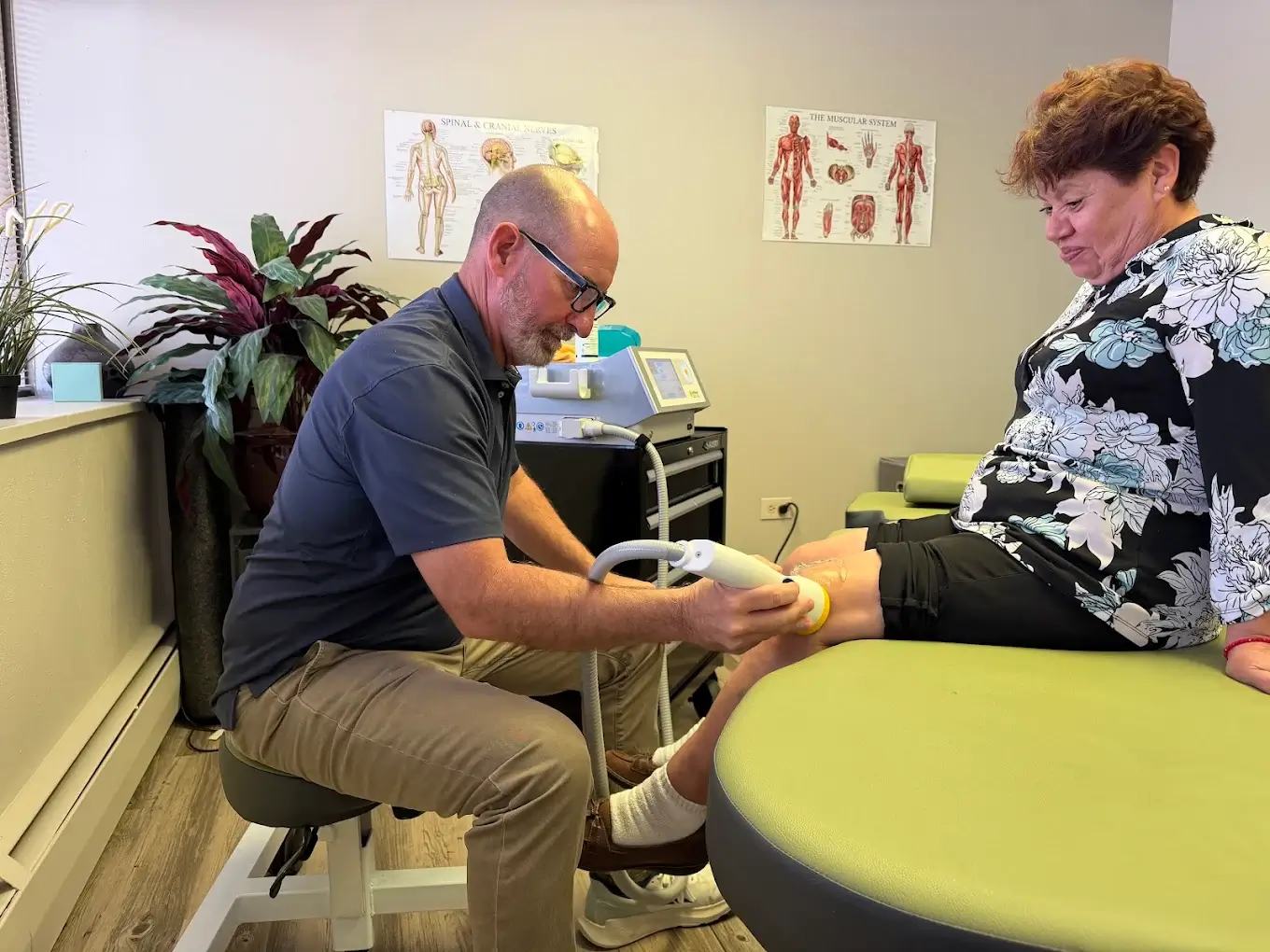 Shockwave therapy being applied to a patient's shoulder at Axis Health and Wellness in Centennial CO