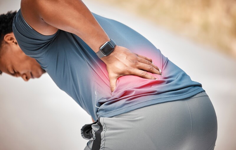 Person with low back and sciatica pain radiating down the leg in Centennial CO
