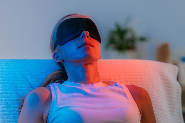 TheraRay red light therapy unit being applied to a patient at Axis Health and Wellness in Centennial CO