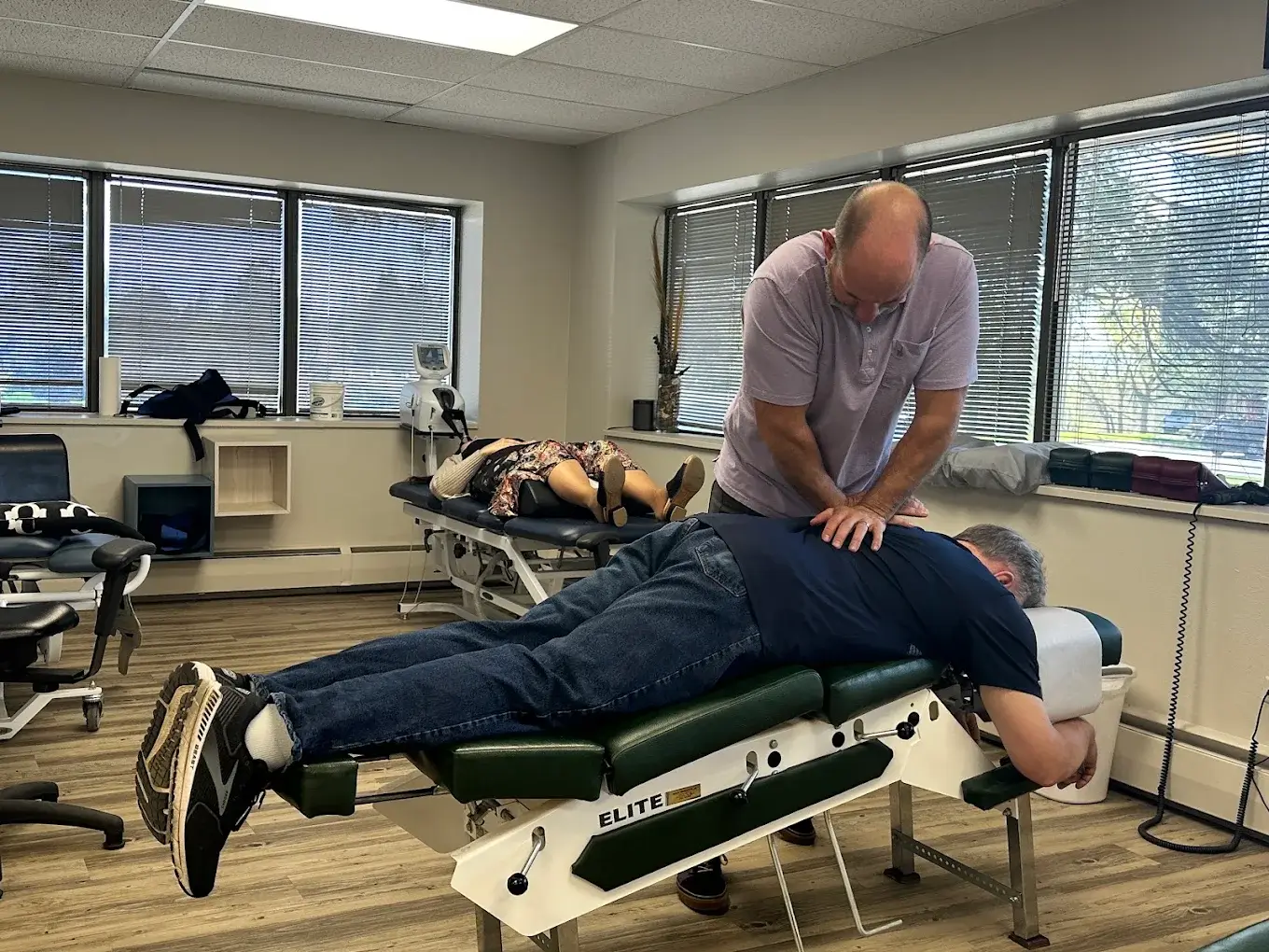 Dr. Tony Nicholas performing a chiropractic adjustment on a patient back at Axis Health and Wellness in Centennial CO